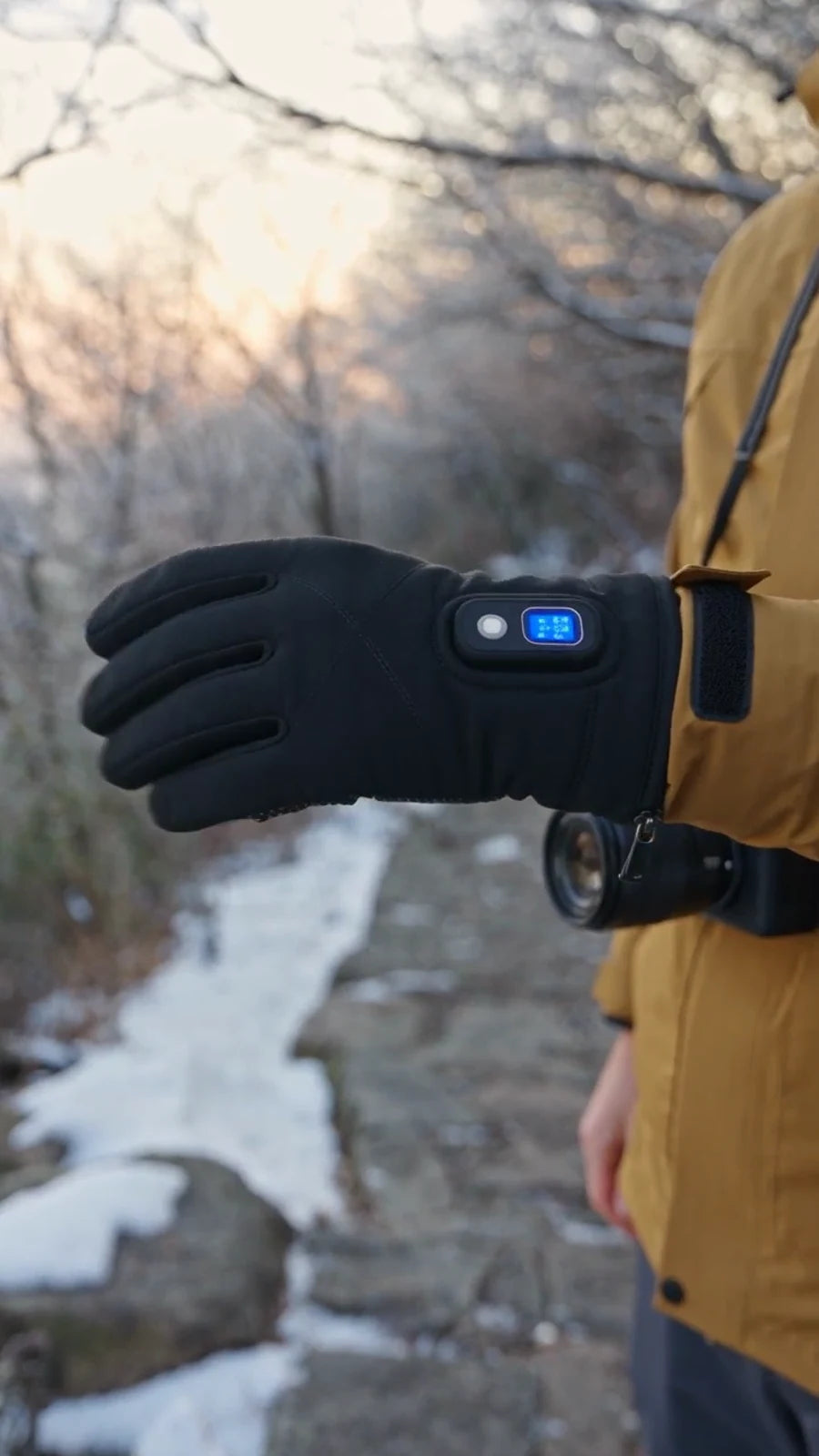 Close view of the digital control on a black heated glove